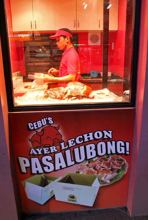 Vendor preparing our order at Ayer Lechon in Cebu