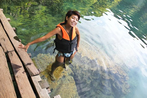 Happy tourist posing at Kayangan Lake