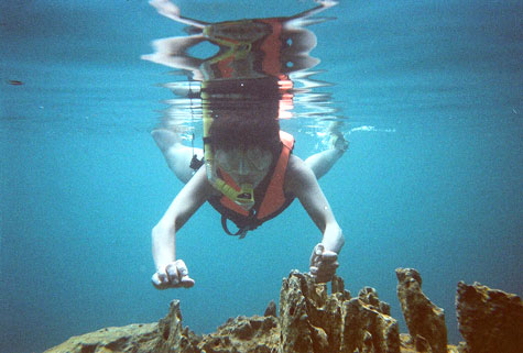 Happy tourist swimming in Kayangan Lake