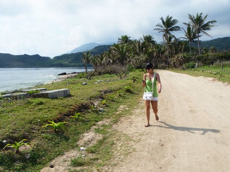 Ren walking on a dirt road towards Kapuluan Vista Resort