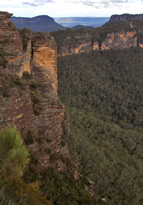 View of cliffside with rock climbers