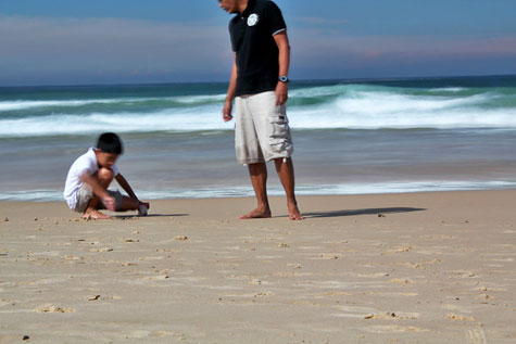 Kid playing on the sands of Bondi Beach, Sydney, Australia