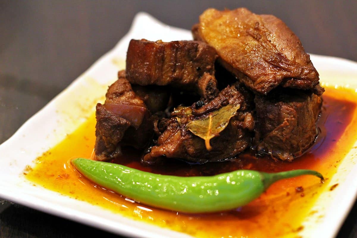 Adobo cooked in bay leaf, soy sauce, and vinegar, a Filipino national dish