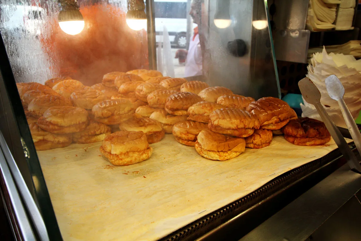 Turkish islak burgers drenched in tomato sauce