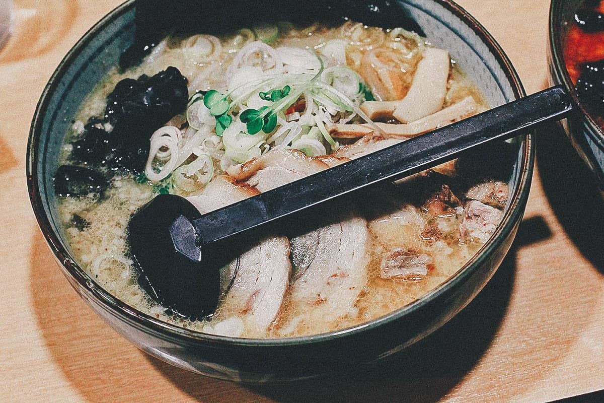 Bowl of miso ramen with wheat noodles, scallions, and thin slices of pork