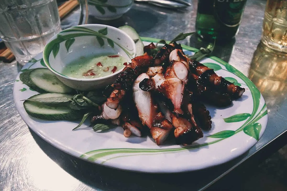 Vietnamese Food Guide: What to Eat in Vietnam Bach Tuoc Nuong Sa Te in Saigon, a tasty Vietnamese street food dish made with grilled octopus
