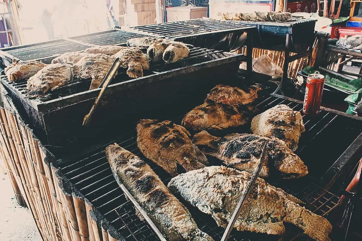 Pla pao or salt-crusted fish at a floating market in Bangkok