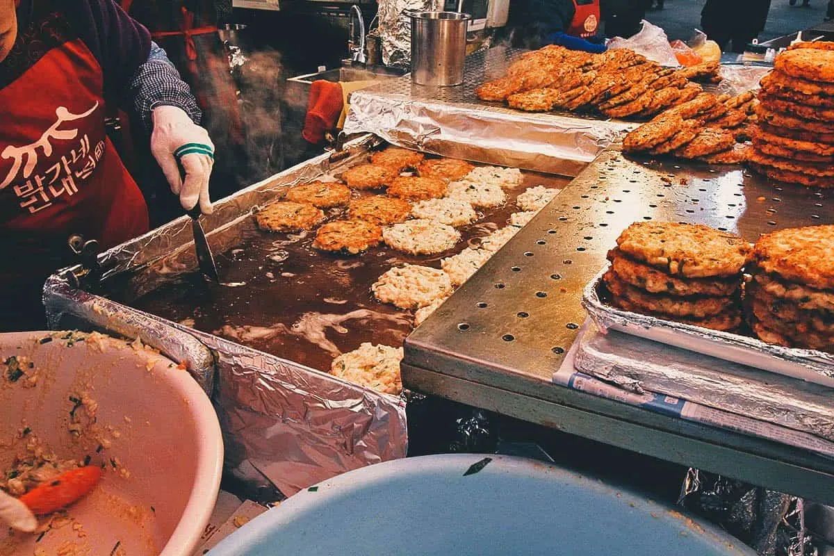 Cooking bindaetteok at Gwangjang Market in Seoul, South Korea