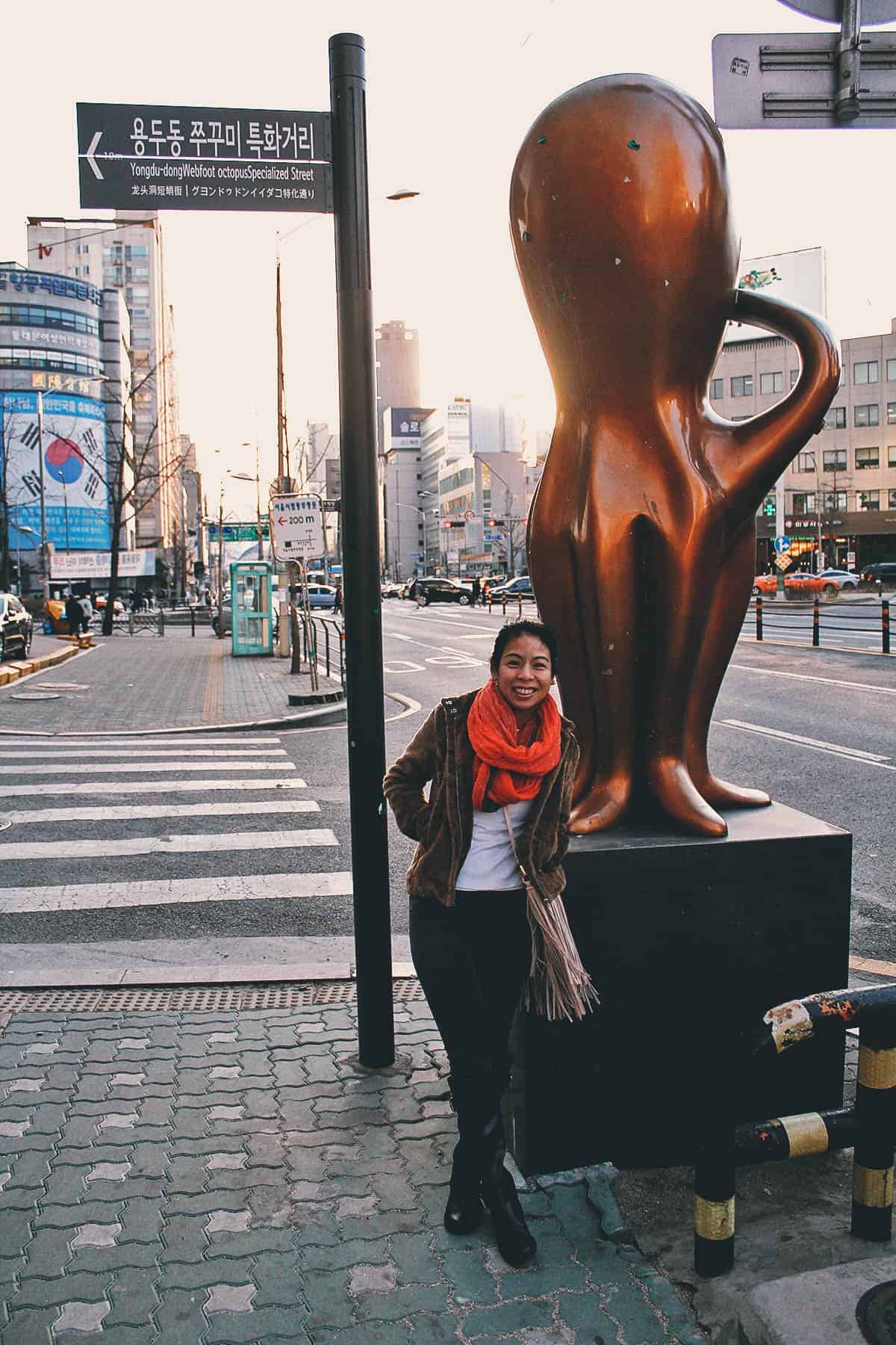 Ren posing next to the octopus statue
