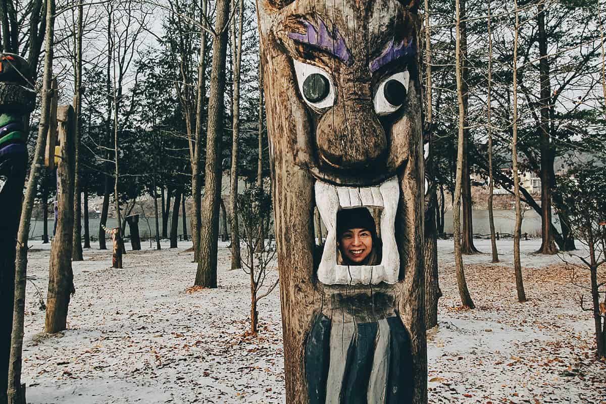 Ren posing with a tree on Nami Island in South Korea