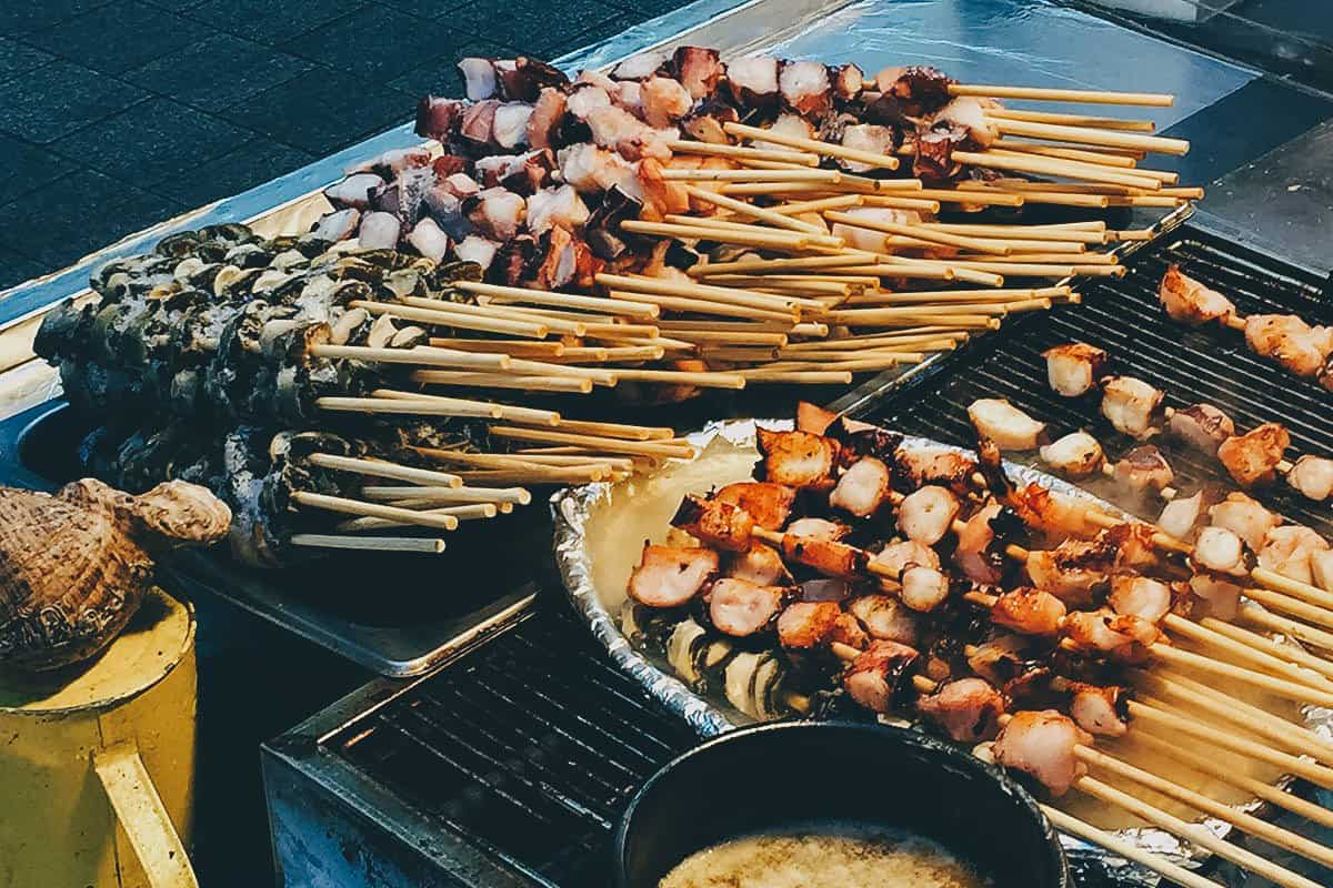 Steamed octopus and conch skewers from street vendors