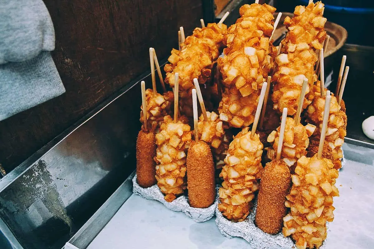 Things to Eat in South Korea Tokkebi hot dogs covered in french fries