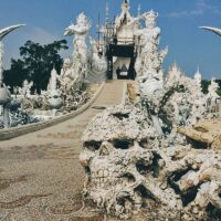 Explore Wat Rong Khun (White Temple), Baan Dam Museum (Black House), and Wat Rong Suea Ten (Blue Temple) in Chiang Rai, Thailand