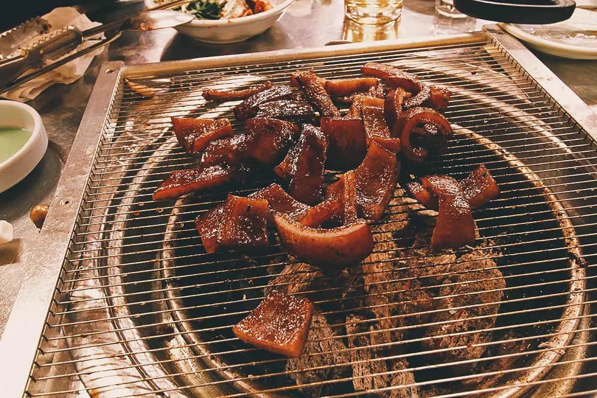 Things to Eat in South Korea Pork rinds grilling at a restaurant in Seoul