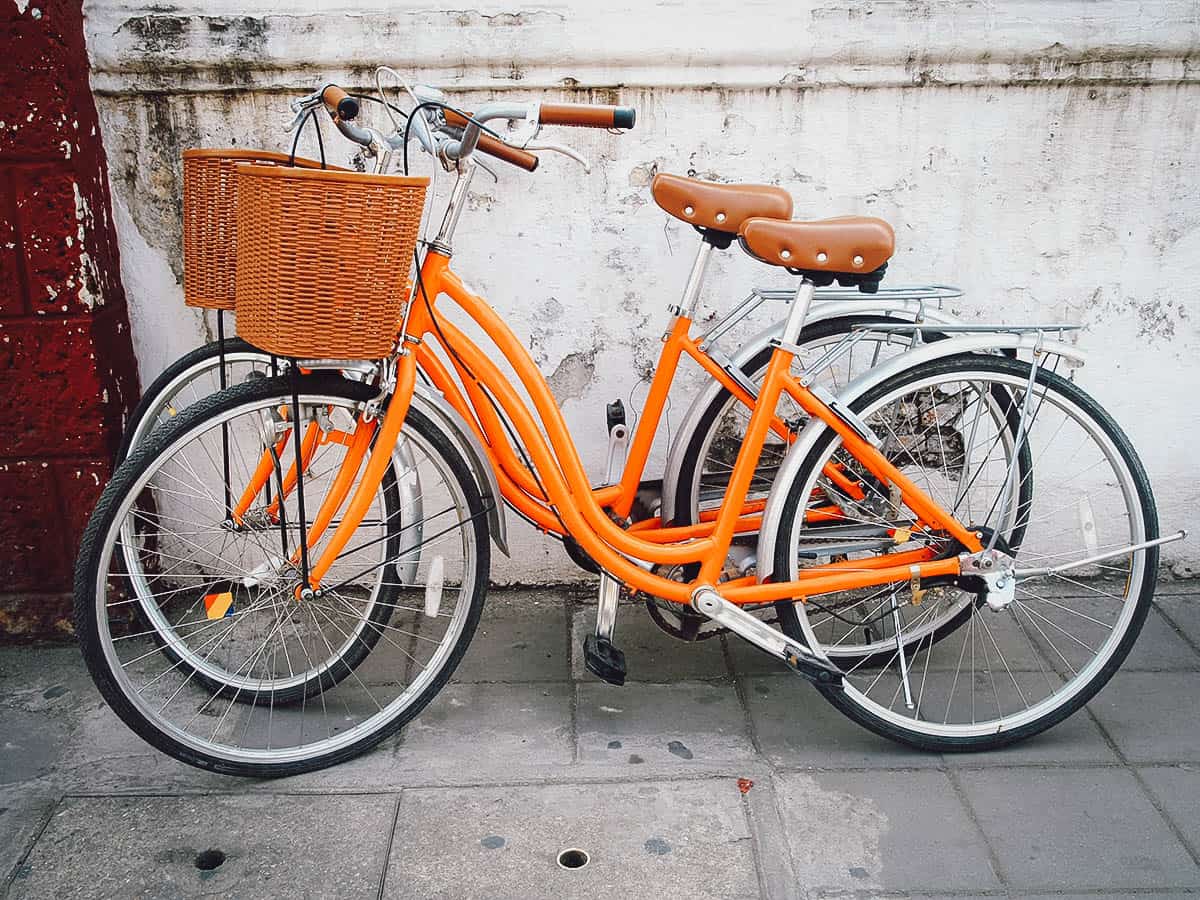 Orange bicycles with baskets