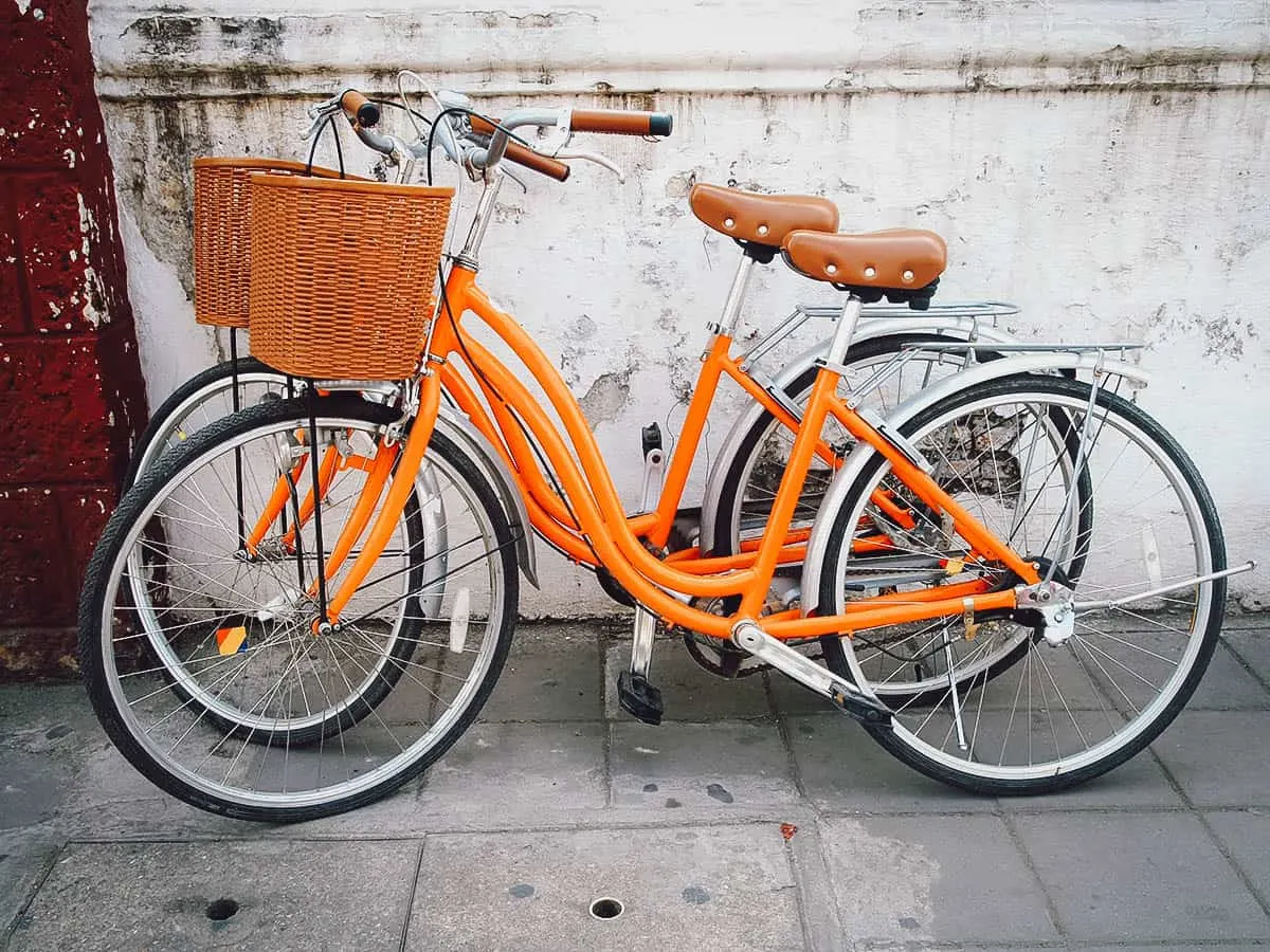 Orange bicycles with baskets