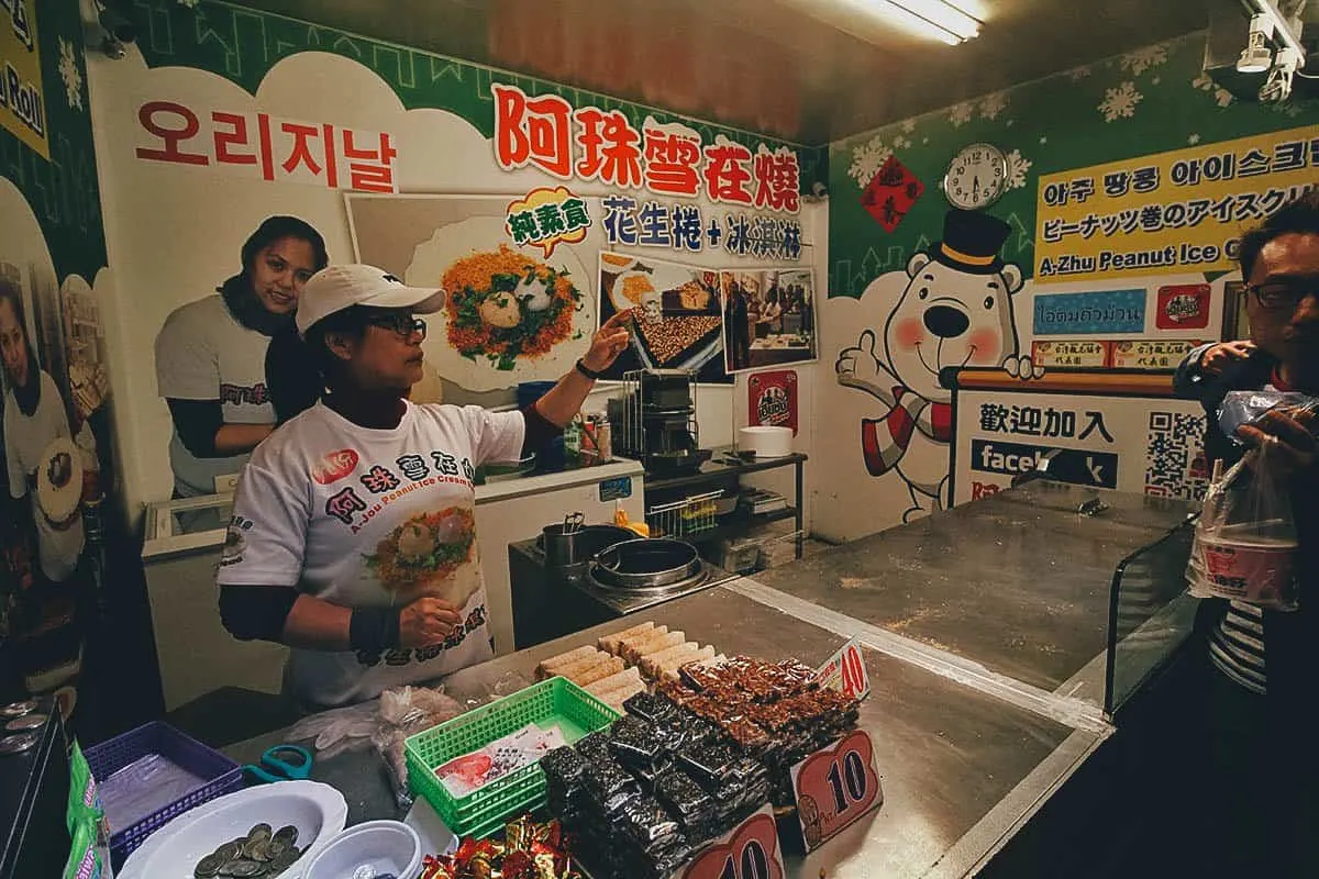 10 Things to Eat on Jiufen Old Street, Taiwan Street food vendor selling peanut ice cream cakes on Jiufen Old Street, Taiwan