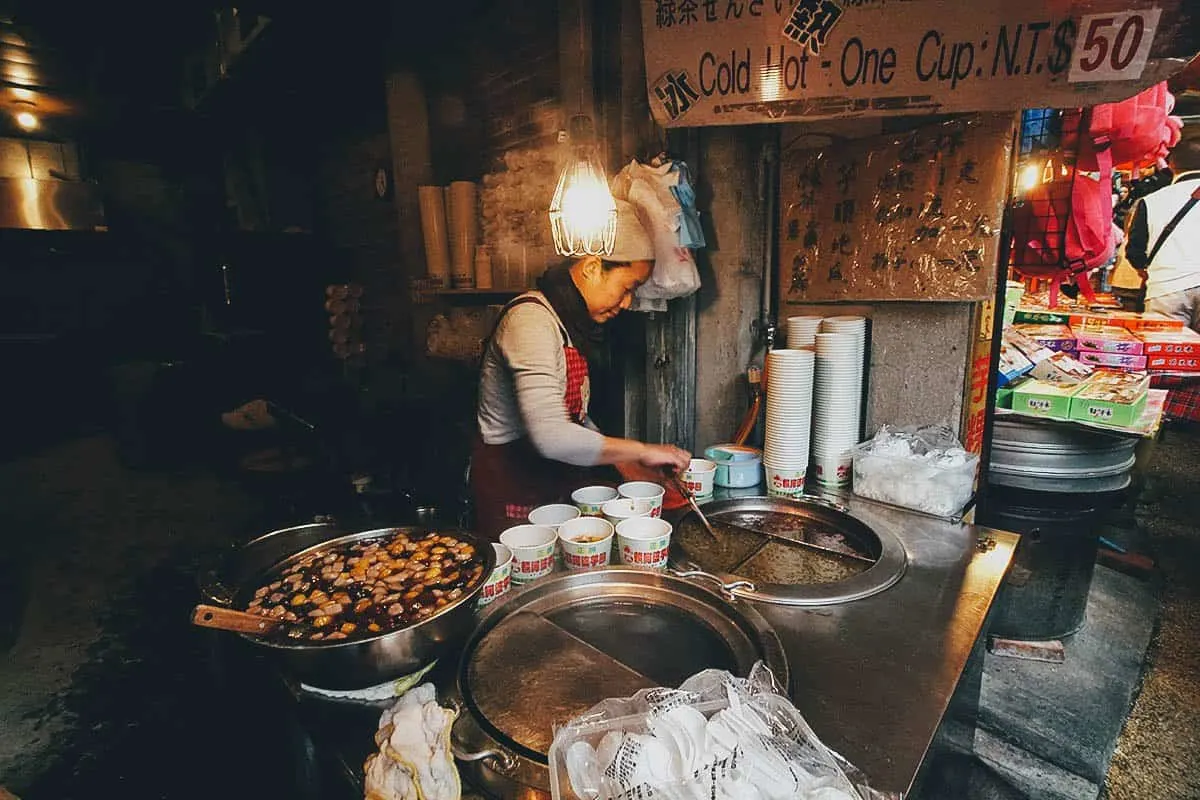 10 Things to Eat on Jiufen Old Street, Taiwan Street food vendor selling taro balls on Jiufen Old Street, Taiwan