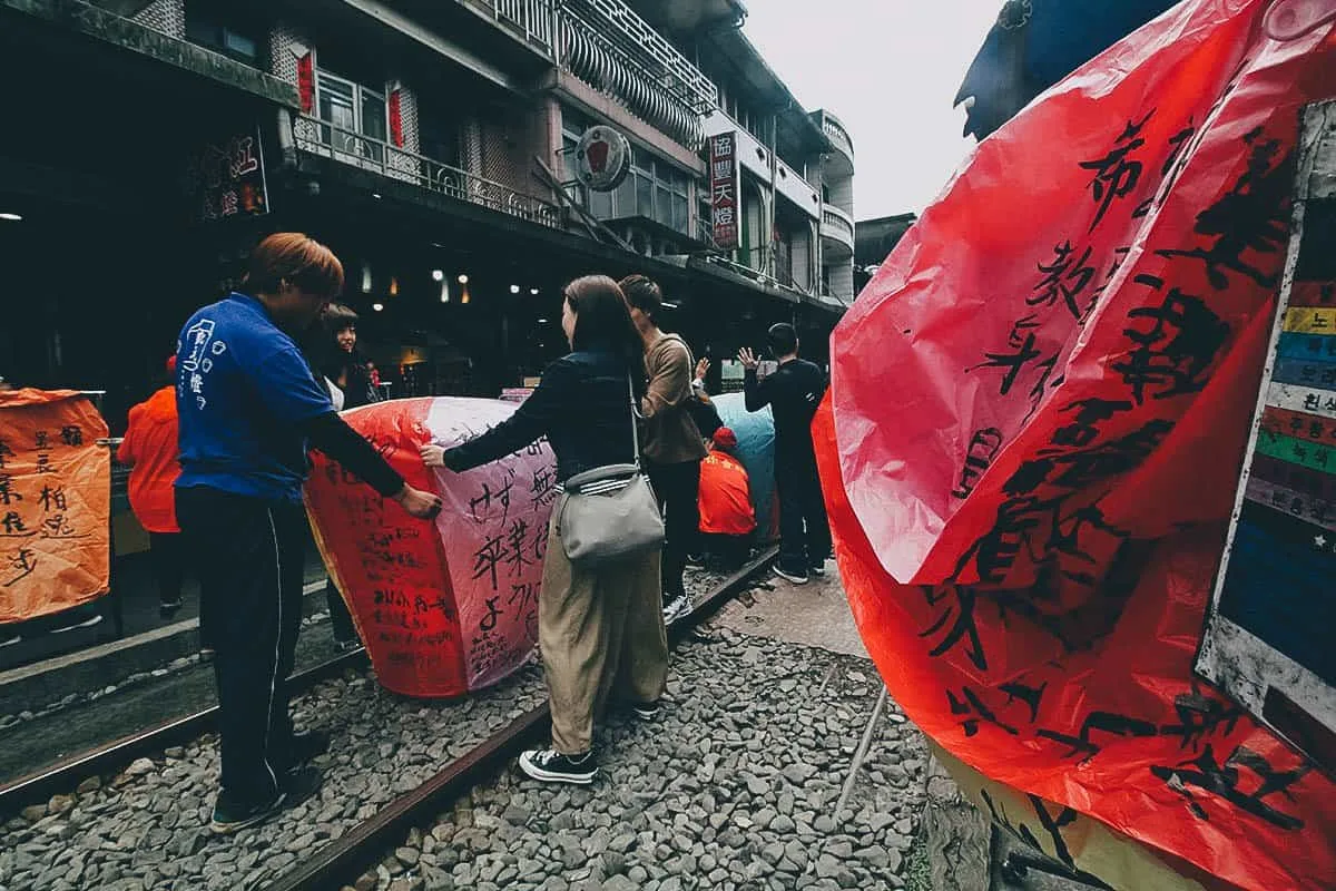 Tourists with lanterns at Shifen Old Street, New Taipei City, Taiwan