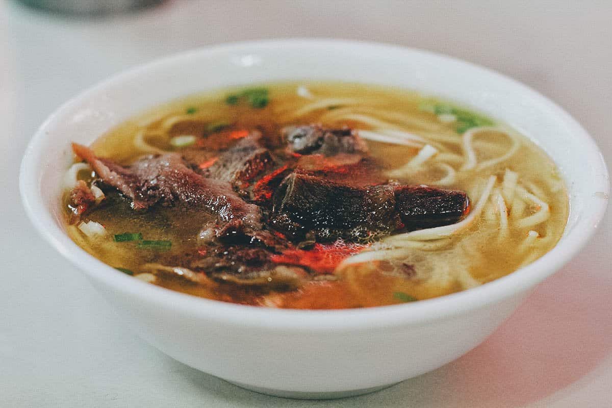 Bowl of clear beef noodle soup at Tao-Yuan Street Beef Noodle Shop in Taipei, Taiwan