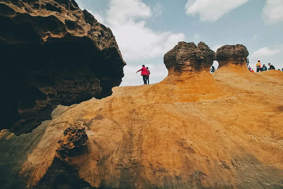 Yehliu Geopark, New Taipei City, Taiwan Tourists between rock formations at Yehliu Geopark, New Taipei City, Taiwan