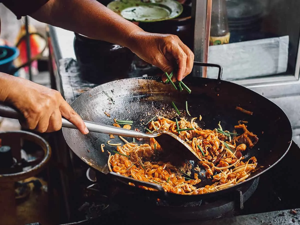 Cooking char koay teow in a wok