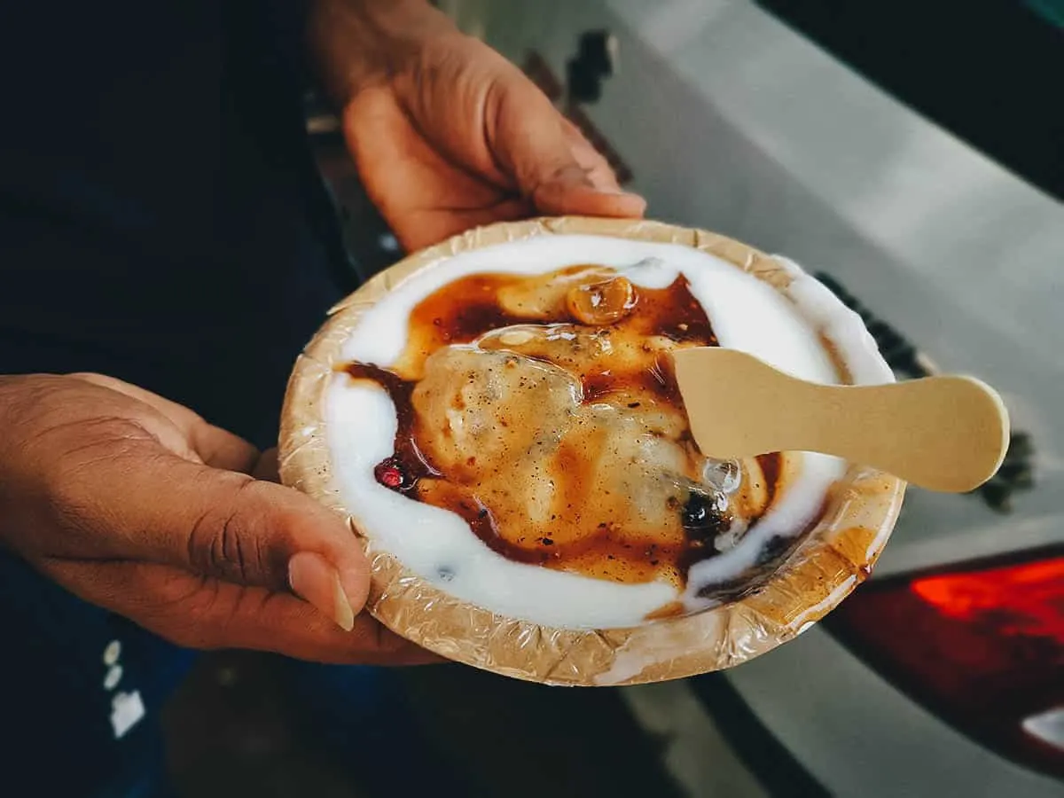 Dahi vadas in yogurt sauce at an Indian street food stall in Delhi