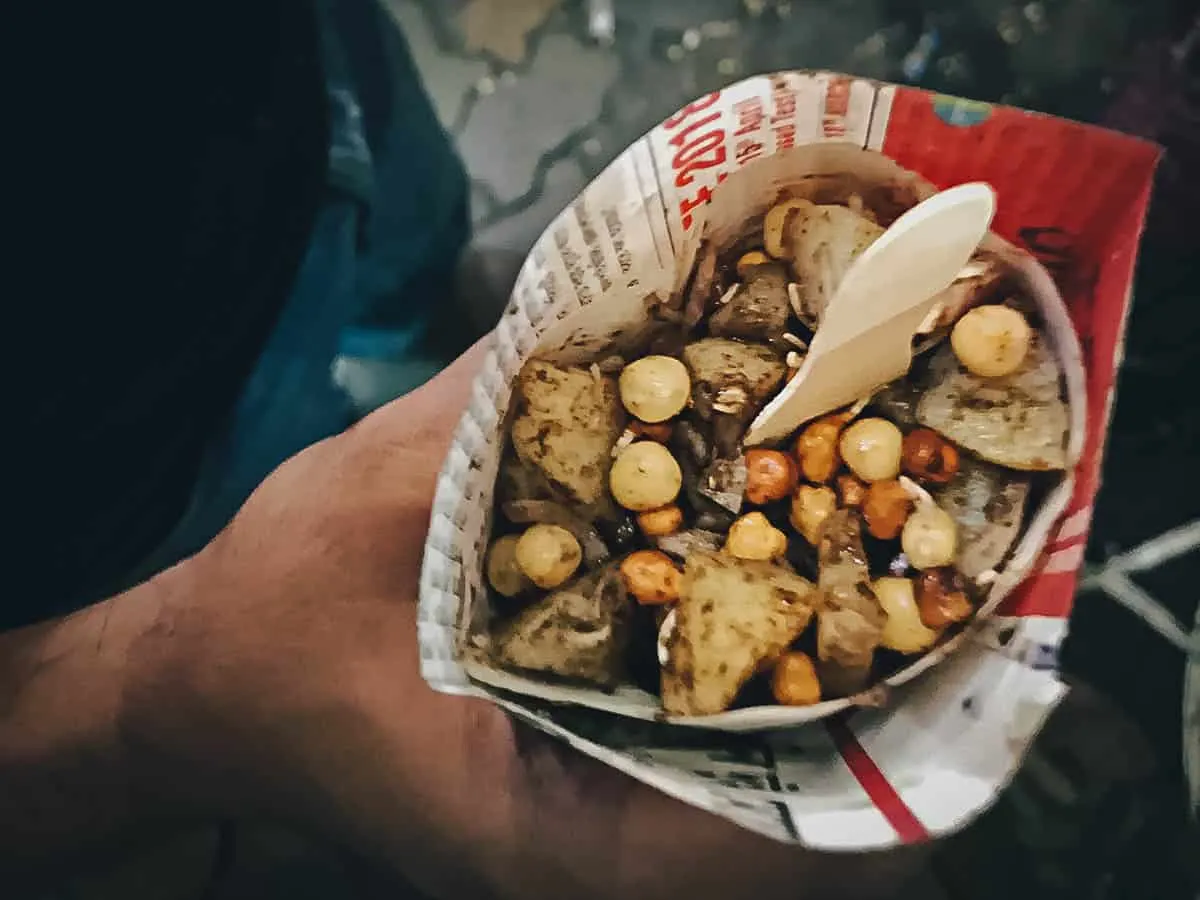 Indian Street Food Aloo chana chaat in a small bag, one of the most common street foods in India