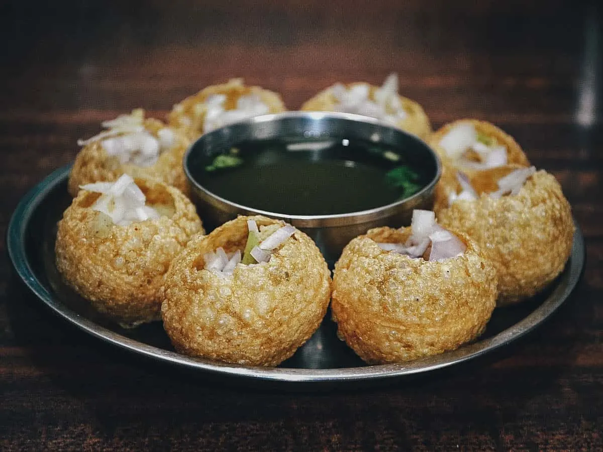 Pani puri filled with onions and green chilies, one of the most popular street foods in India