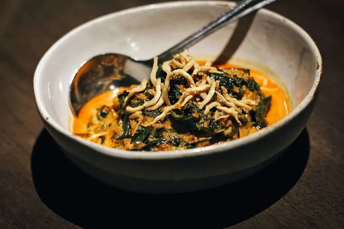 From the tasting menu: Bowl of Peranakan vegetable soup on a dark dining room table