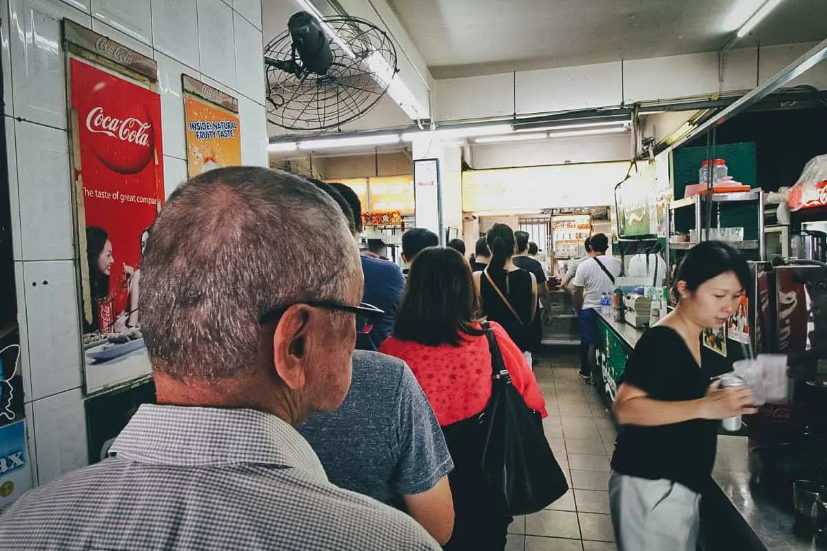 Long line of people waiting to eat Michelin pork noodles