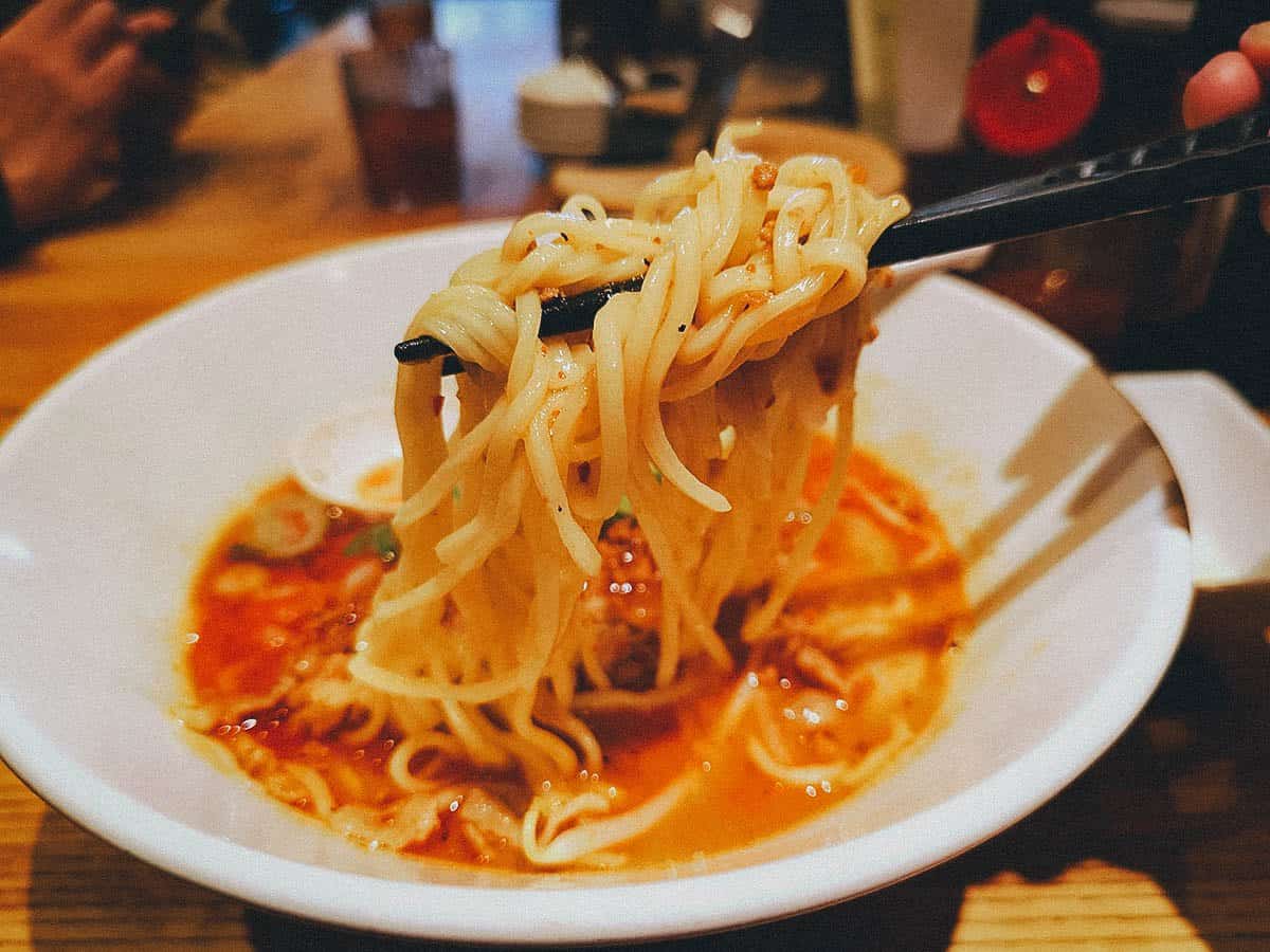 Showing off ramen noodles at Ippudo restaurant in Osaka