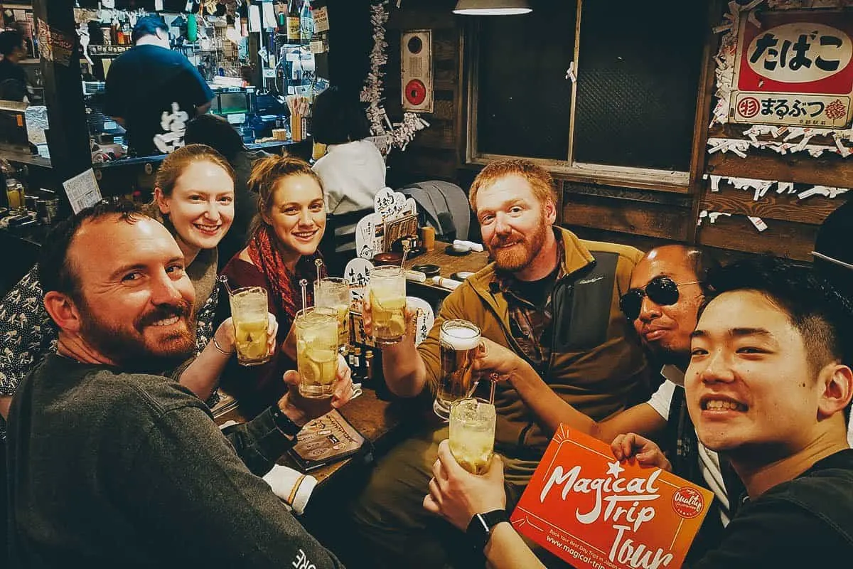 Tourists at an izakaya in Osaka drinking beer