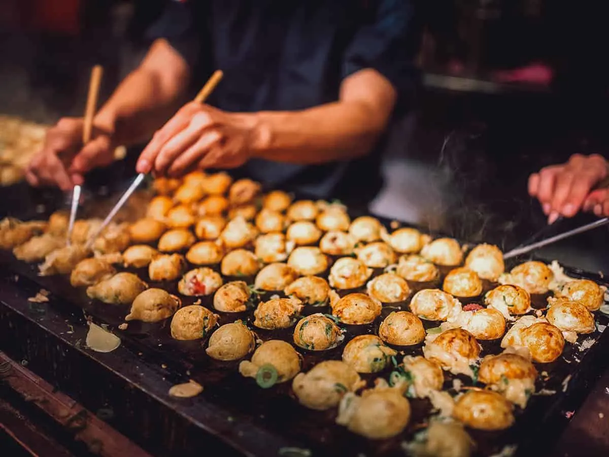 Street vendors cooking takoyaki balls
