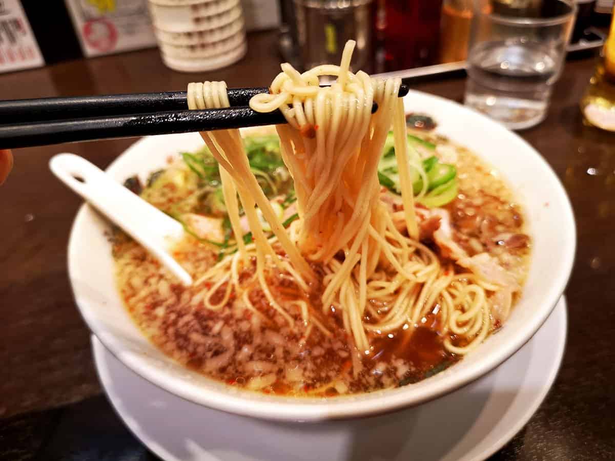 Showing off ramen noodles at Rai Rai Tei restaurant in Osaka