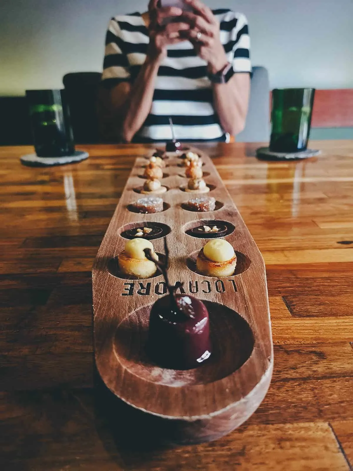 JB & Ren, the Traveleaters of Will Fly for Food Dessert on a sungka board in Bali, Indonesia