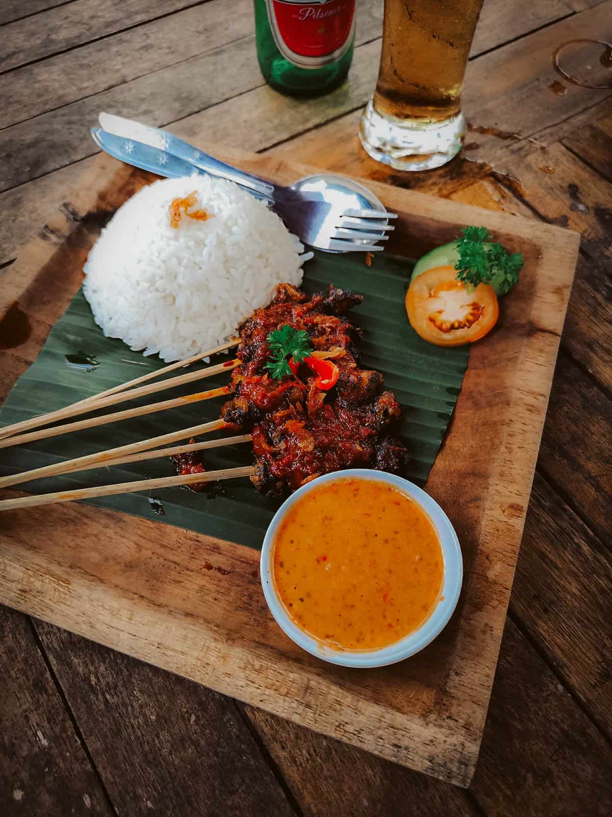 Bali Food Guide: 14 Must-Eat Restaurants in Bali, Indonesia Snail satay and rice at an Indonesian restaurant in Bali