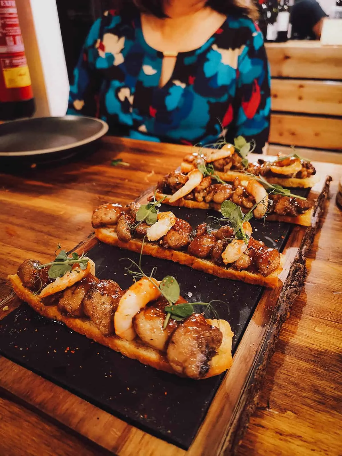 Lamb sweetbreads with prawn and garlic on melba toast