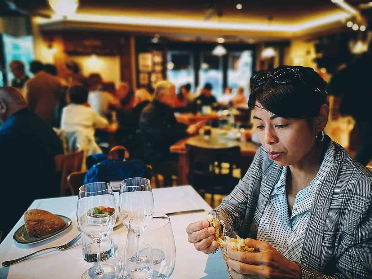 Ren breaking bread at the La Corte de Pelayo restaurant in Oviedo, Spain