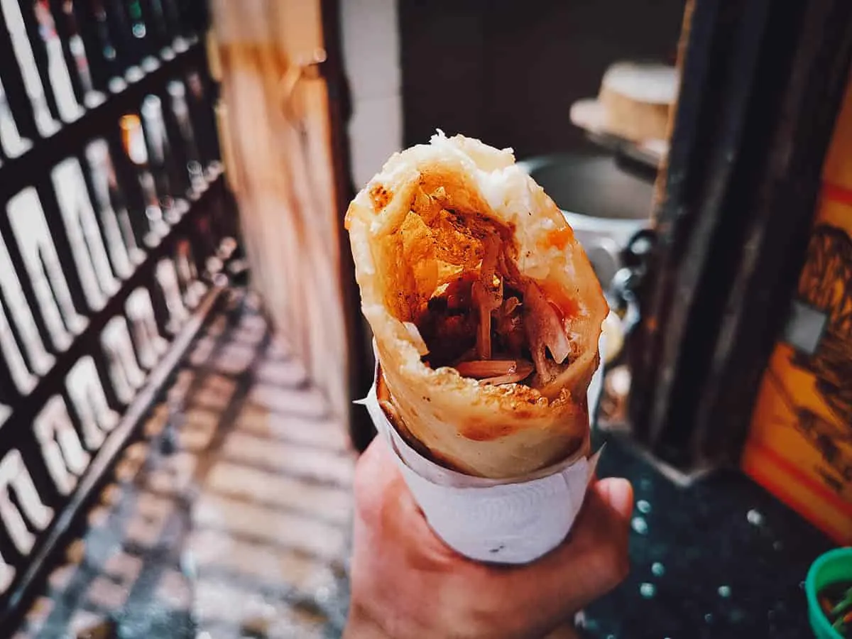 Indian Street Food Chicken tikka kathi roll at a street food stall in Kolkata