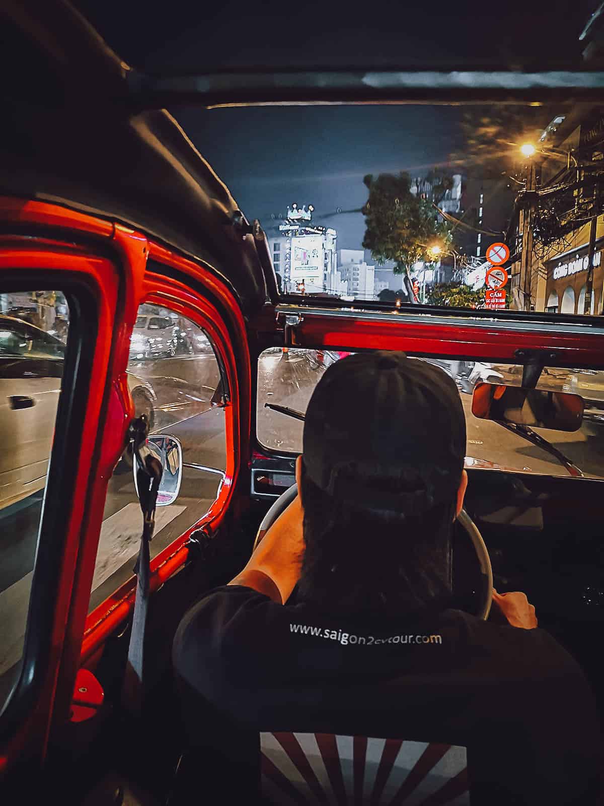 Driving in Saigon at night in a vintage Citroen 2CV in Saigon