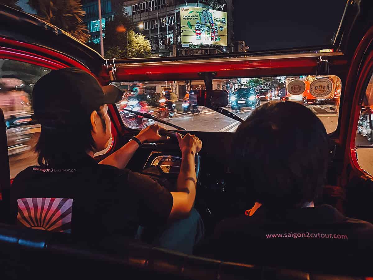 Driving in Saigon at night in a vintage Citroen 2CV in Saigon