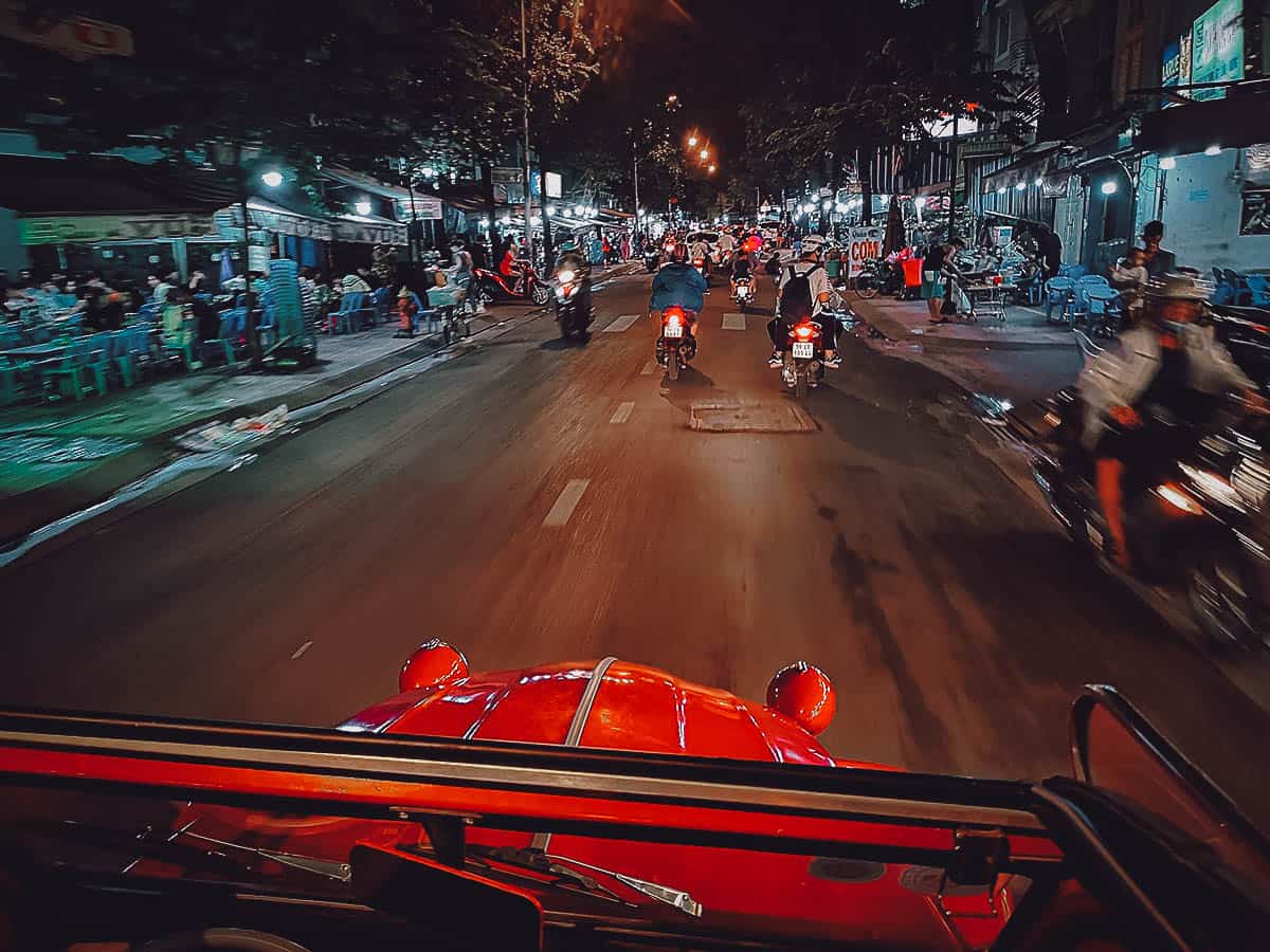 Driving in Saigon at night in a vintage Citroen 2CV in Saigon