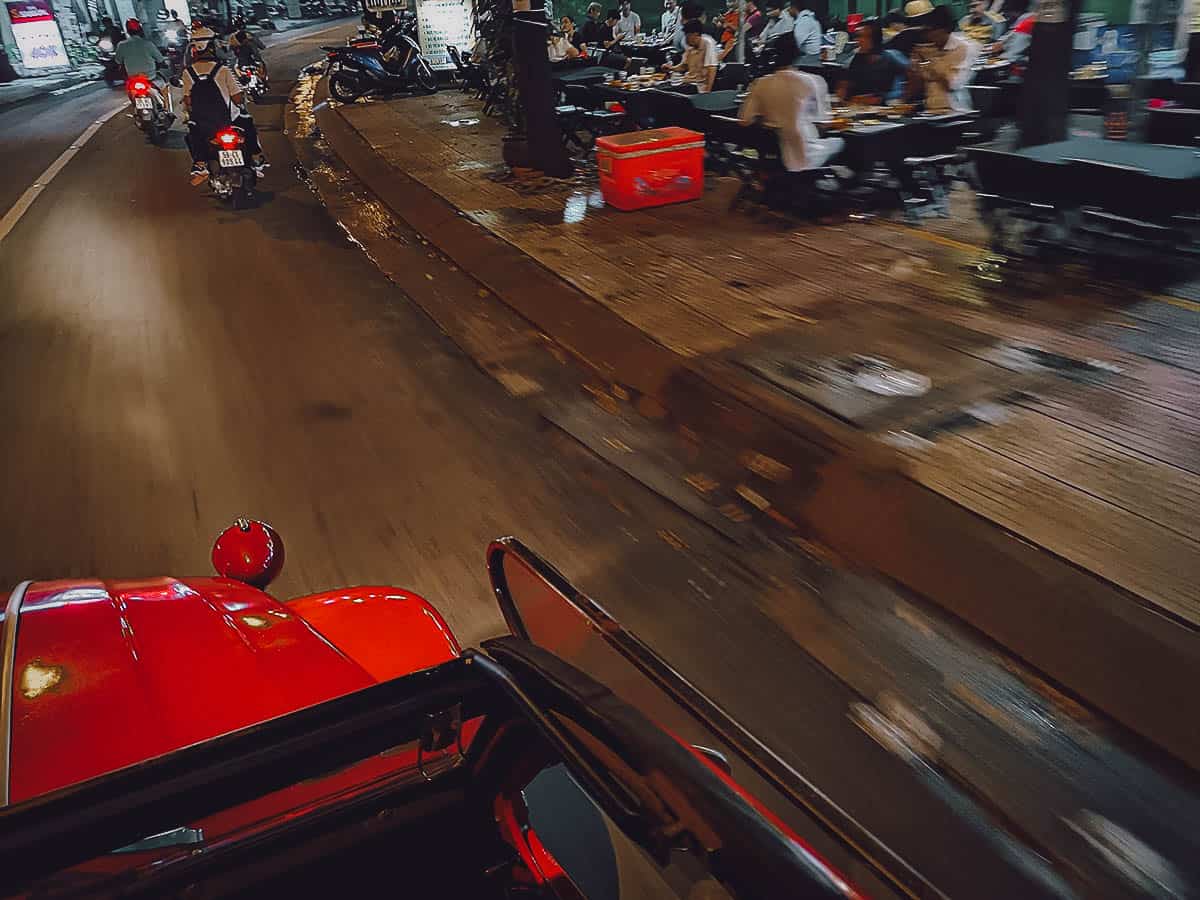 Driving in Saigon at night in a vintage Citroen 2CV in Saigon