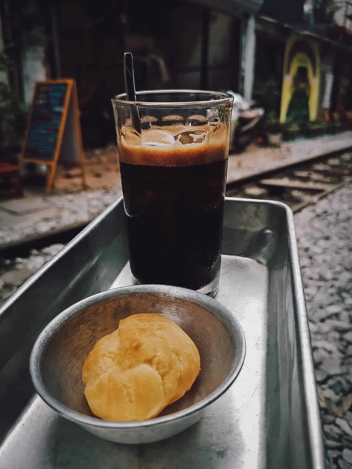 Black coffee and cream puff at The Railway Hanoi