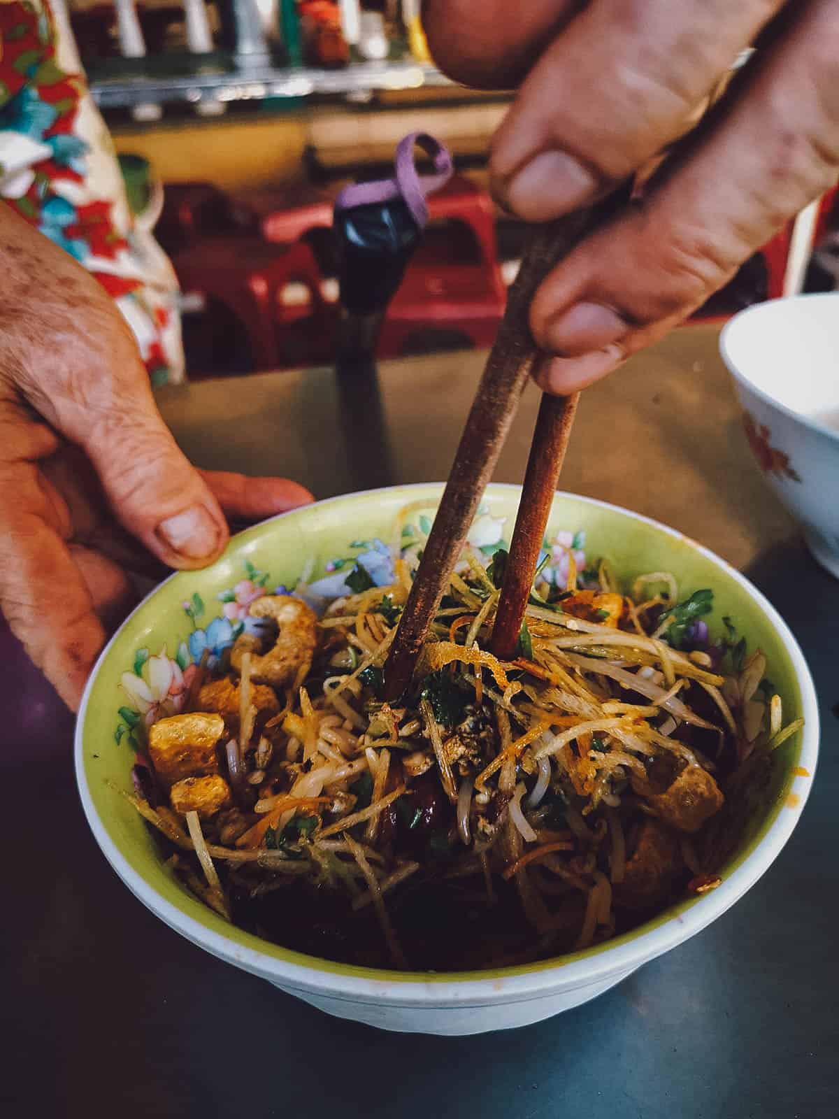 Woman mixing bowl of com hen