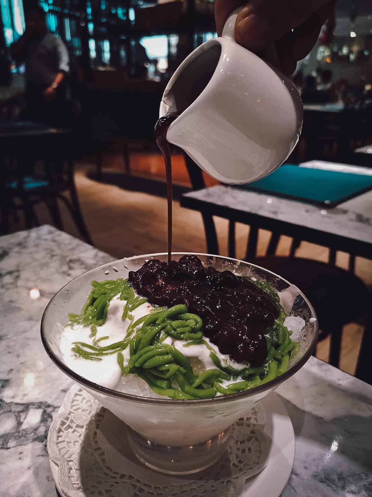 Pouring syrup into a cendol, a famous local dessert in Singapore