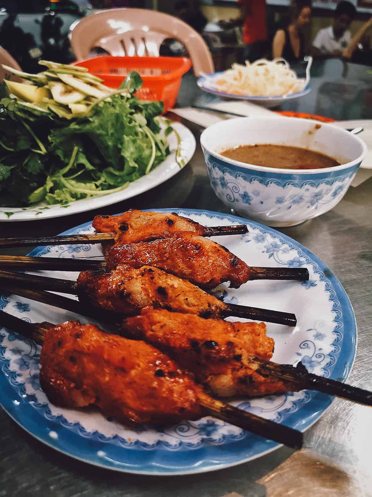 Nem lui, a tasty Vietnamese dish made with skewered grilled fatty pork and peanut sauce