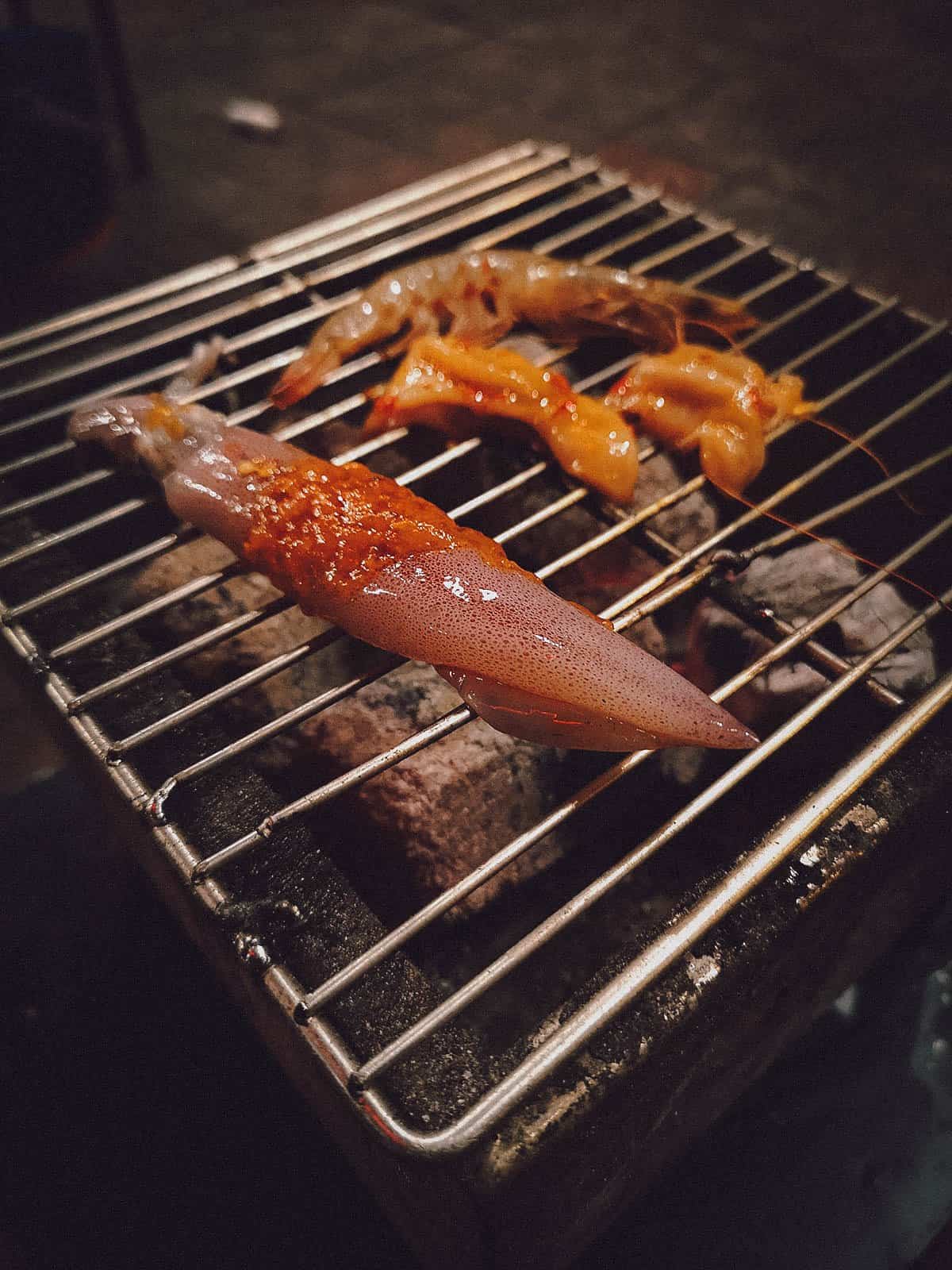 Grilling seafood at Moi restaurant in Hoi An, Vietnam