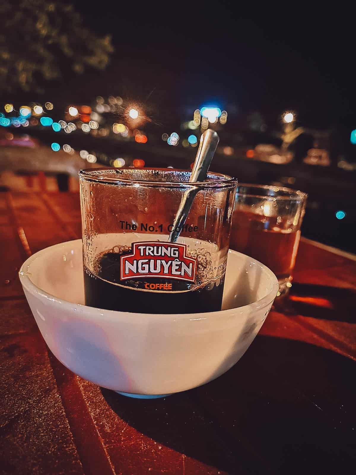 Black coffee by the river in Hoi An, Vietnam